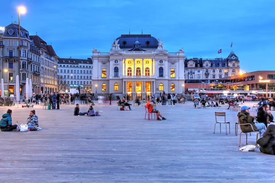 People in large plaza in front of Zurich Opera House in Switzerland.